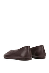A single black leather loafer with a woven detail across the vamp, shown in a side profile on a plain white background.