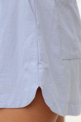 Close-up of curved split hem detail on Bowie Cotton Shorts in Chalk Blue