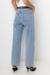 Light blue jeans worn by a person on a white background