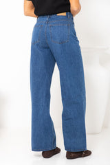 River wide-leg denim jeans in mid blue, high-waisted straight-leg jeans styled with a black t-shirt and woven leather flats