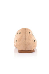 A single tan suede flat shoe shown from the back, featuring small black embroidered details and a brown sole, set against a plain white background.