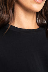 Close-up of a person wearing a black shirt with a blurred background
