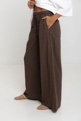 Landon wide leg check pants in chocolate brown, drawstring waist trousers with plaid pattern, styled with a white tee and mesh flats