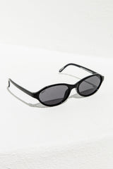 Black sunglasses with a white frame on a light gray background