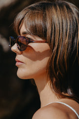 Woman wearing sunglasses with a blurred background