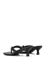 A pair of black leather thong sandals with kitten heels, shown from a side profile on a clean white background.