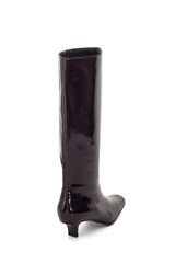 A single knee-high boot in a glossy dark plum patent leather, shown from a rear three-quarter view against a plain white background.