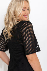 Airlie crochet dress in black, open-weave knit dress with short sleeves, styled with a black leather bucket bag and printed slide sandals