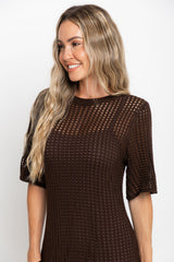 Airlie crochet midi dress in chocolate brown, open-weave knit midi dress with short sleeves, styled with a tan tote bag and thong sandals
