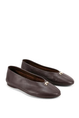 A pair of black leather penny loafers featuring prominent silver-tone metal studs and rhinestone embellishments across the vamp, displayed on a clean white background.
