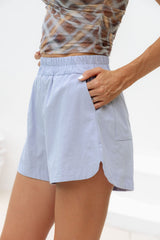 Side view of women’s Bowie Cotton Shorts in Chalk Blue with side pocket and hand in pocket