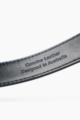A close-up of a dark gray leather strap with debossed text reading 'Genuine Leather Designed in Australia' on a clean white background.
