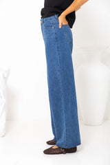 River wide-leg denim jeans in mid blue, high-waisted straight-leg jeans styled with a black t-shirt and woven leather flats
