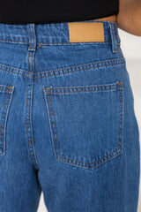 River wide-leg denim jeans in mid blue, high-waisted straight-leg jeans styled with a black t-shirt and woven leather flats