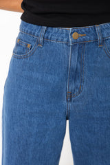 River wide-leg denim jeans in mid blue, high-waisted straight-leg jeans styled with a black t-shirt and woven leather flats