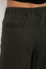 Black pants with a pocket detail on a plain background