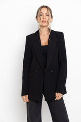 Woman wearing a black blazer on a white background