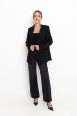 Woman wearing a black suit on a white background