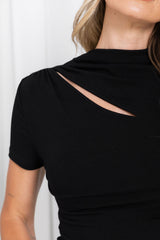 Close-up of a woman wearing a fitted black short-sleeve top with a diagonal cutout across the upper back, against a light neutral background.