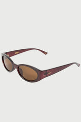 Oval sunglasses with dark reddish-brown frames and brown lenses, shown at an angle on a light gray background.