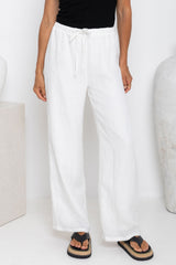 Willow straight-leg linen pants in white, drawstring waist trousers styled with a black tank top and platform flip-flop sandals