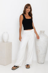 Willow straight-leg linen pants in white, drawstring waist trousers styled with a black tank top and platform flip-flop sandals