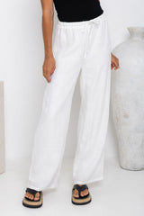 Willow straight-leg linen pants in white, drawstring waist trousers styled with a black tank top and platform flip-flop sandals