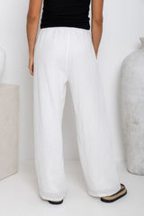 Willow straight-leg linen pants in white, drawstring waist trousers styled with a black tank top and platform flip-flop sandals